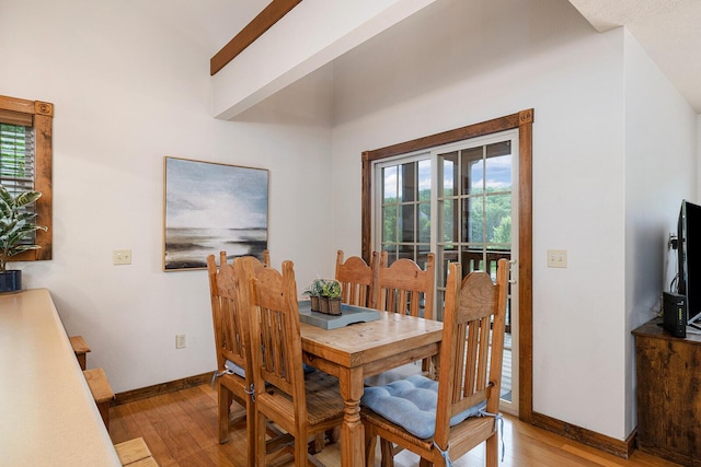 dining area featuring baseboards and light wood-style floors