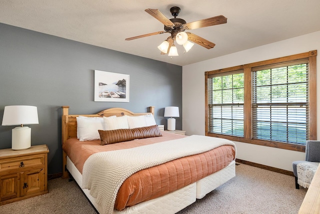 bedroom featuring light carpet, ceiling fan, and baseboards