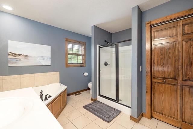 bathroom featuring visible vents, toilet, a shower stall, tile patterned flooring, and baseboards