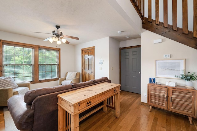 living area featuring light wood finished floors and a ceiling fan