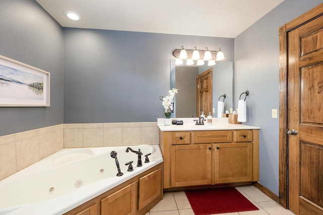 full bath featuring a jetted tub, vanity, and tile patterned floors