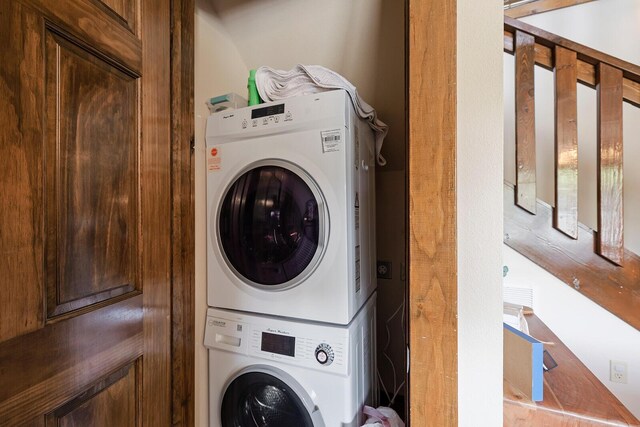 laundry room featuring stacked washer and dryer and laundry area