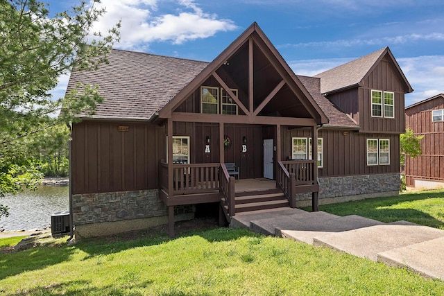 rustic home with stone siding, board and batten siding, and a front yard