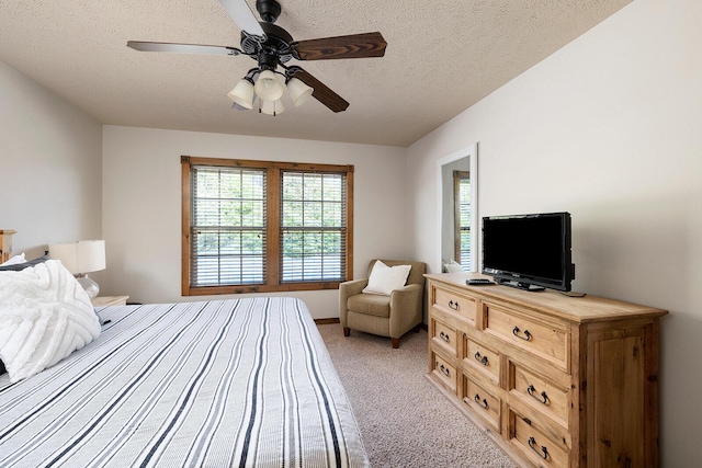 bedroom with light carpet, ceiling fan, and a textured ceiling