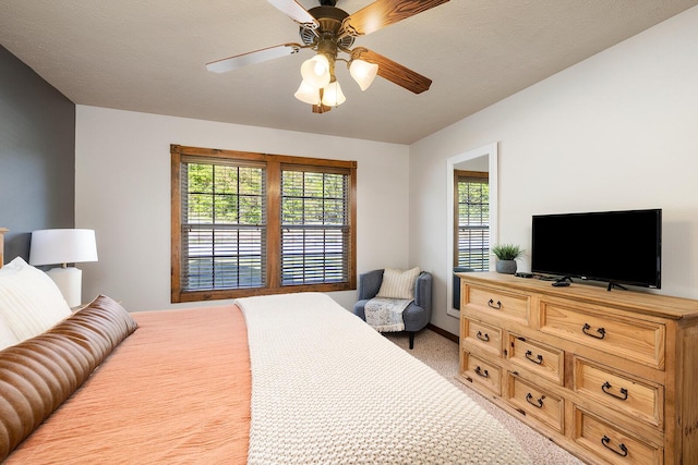 bedroom featuring light colored carpet and ceiling fan