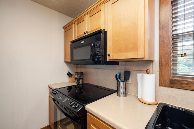 kitchen with a textured ceiling, light brown cabinets, light countertops, black appliances, and tasteful backsplash