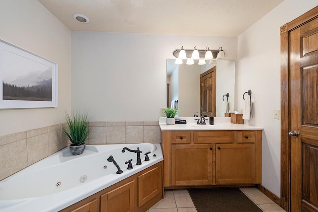 bathroom featuring a jetted tub, tile patterned flooring, and vanity