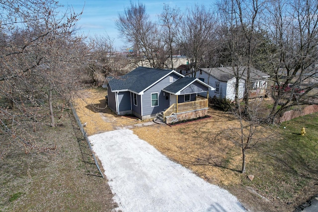 view of front of house with driveway and roof with shingles