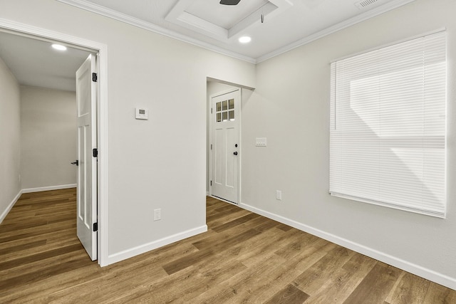 unfurnished room with crown molding, baseboards, wood finished floors, and recessed lighting