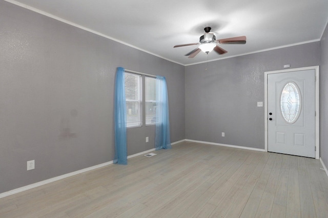 entrance foyer with light wood finished floors, visible vents, baseboards, ceiling fan, and crown molding