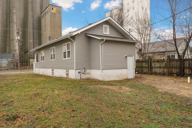 view of home's exterior featuring a yard and fence