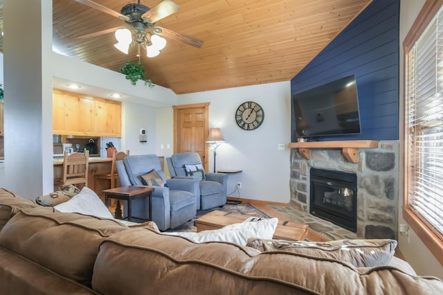 living area featuring a ceiling fan, lofted ceiling, wooden ceiling, and a fireplace