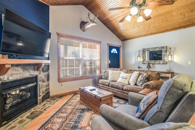 living room with ceiling fan, wooden ceiling, a fireplace, baseboards, and vaulted ceiling