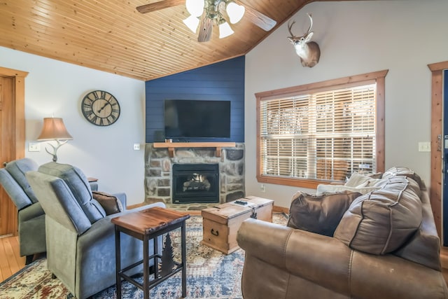 living area with wooden ceiling, ceiling fan, wood finished floors, a fireplace, and high vaulted ceiling