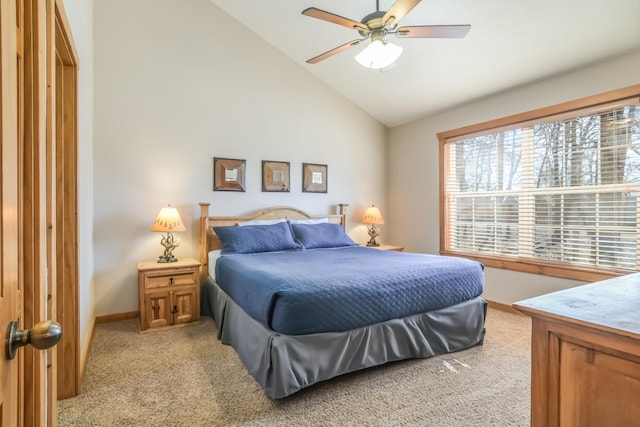 bedroom with light colored carpet, vaulted ceiling, baseboards, and ceiling fan