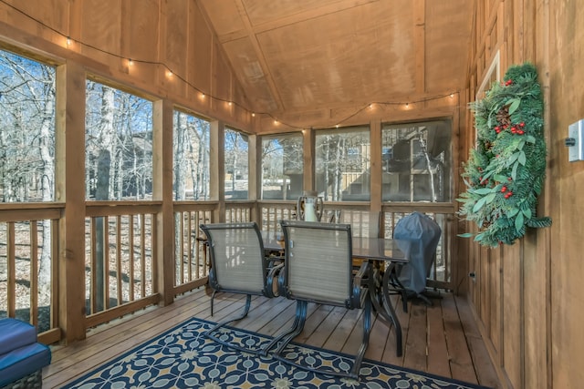 sunroom featuring lofted ceiling and plenty of natural light