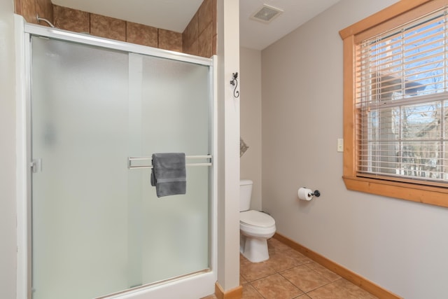 full bathroom with tile patterned flooring, a healthy amount of sunlight, visible vents, and toilet