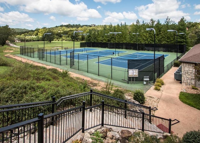 view of sport court featuring fence