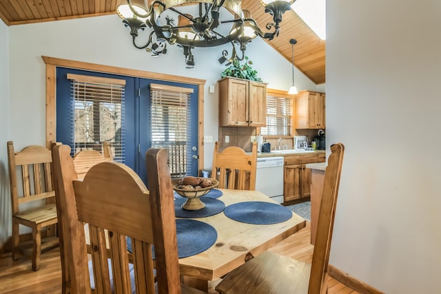 dining area with a chandelier, wooden ceiling, vaulted ceiling, and light wood-style flooring