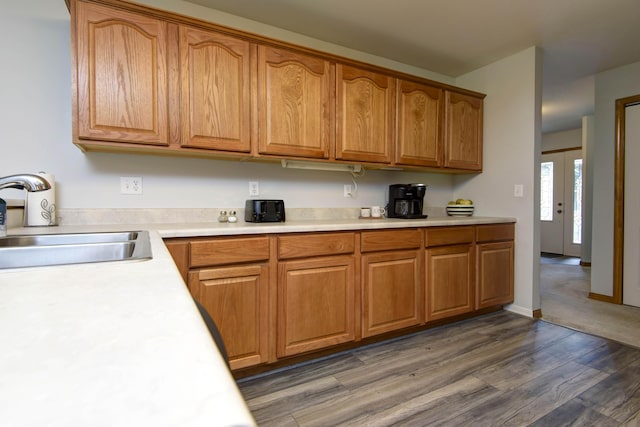 245 Wildflower Rd, Kimberling City, MO 65686 - kitchen with brown cabinetry, dark wood finished floors, light countertops, and a sink