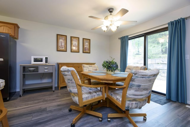 245 Wildflower Rd, Kimberling City, MO 65686 - dining room featuring ceiling fan, baseboards, and wood finished floors