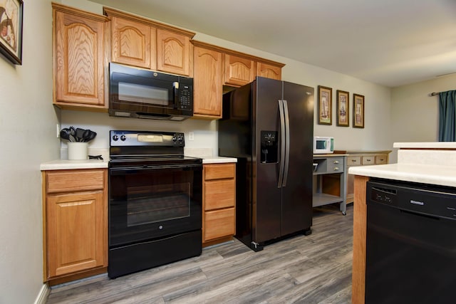 245 Wildflower Rd, Kimberling City, MO 65686 - kitchen featuring light wood-type flooring, black appliances, and light countertops