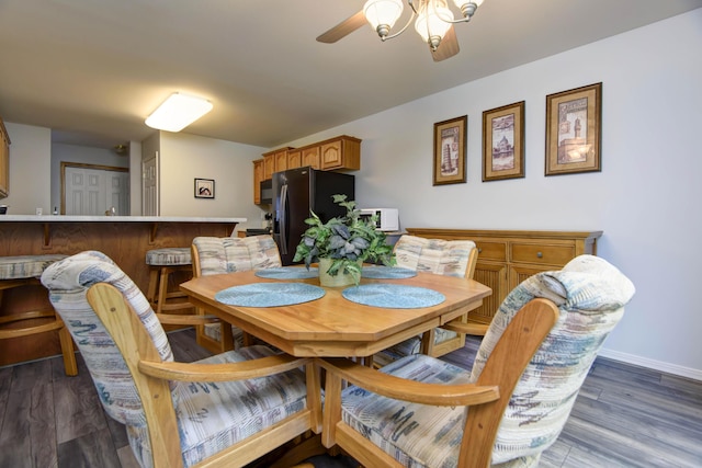 245 Wildflower Rd, Kimberling City, MO 65686 - dining space with wood finished floors, a ceiling fan, and baseboards