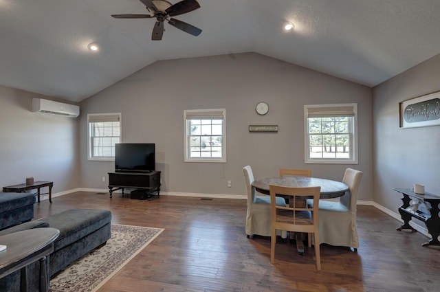 dining area featuring lofted ceiling, dark wood finished floors, a wall mounted air conditioner, and plenty of natural light