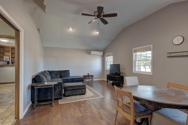 living area featuring baseboards, ceiling fan, wood finished floors, vaulted ceiling, and an AC wall unit