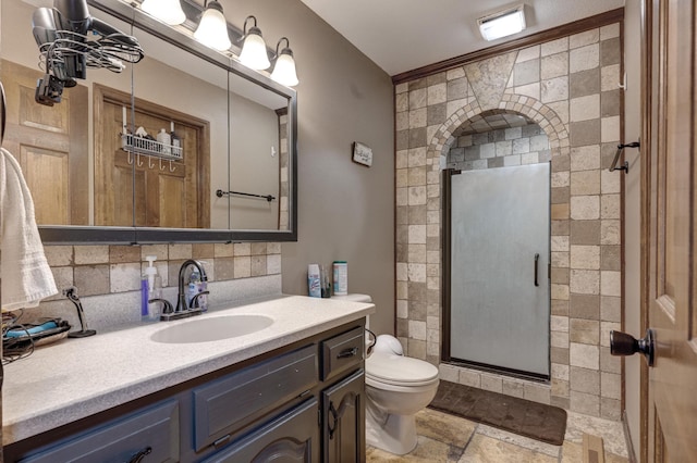 bathroom with stone tile flooring, visible vents, toilet, a stall shower, and vanity