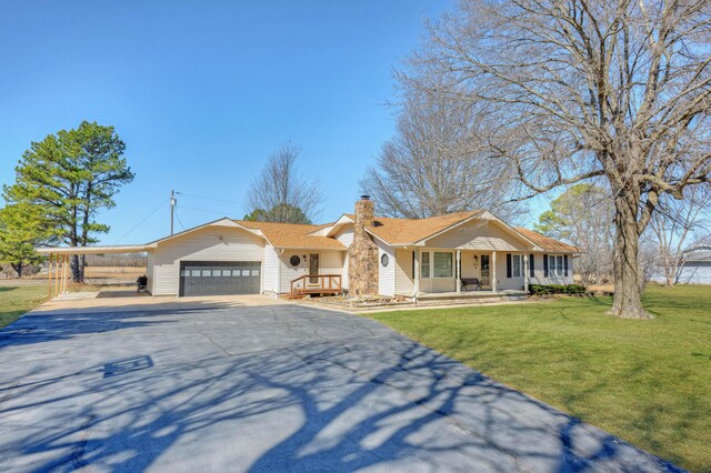 ranch-style home featuring driveway, a chimney, covered porch, a front lawn, and a carport