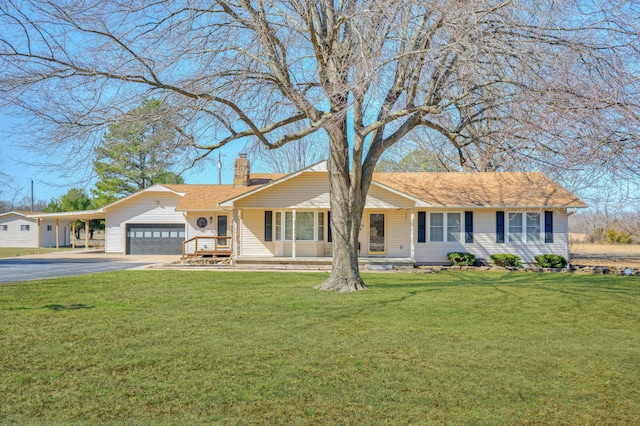 ranch-style home featuring an attached garage, aphalt driveway, a chimney, and a front yard