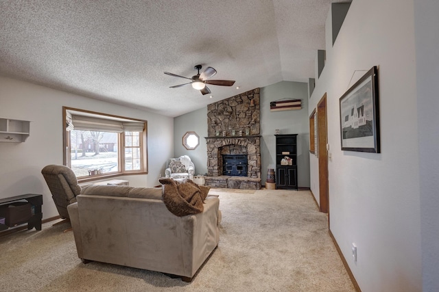 living area with lofted ceiling, a ceiling fan, light carpet, a stone fireplace, and a textured ceiling