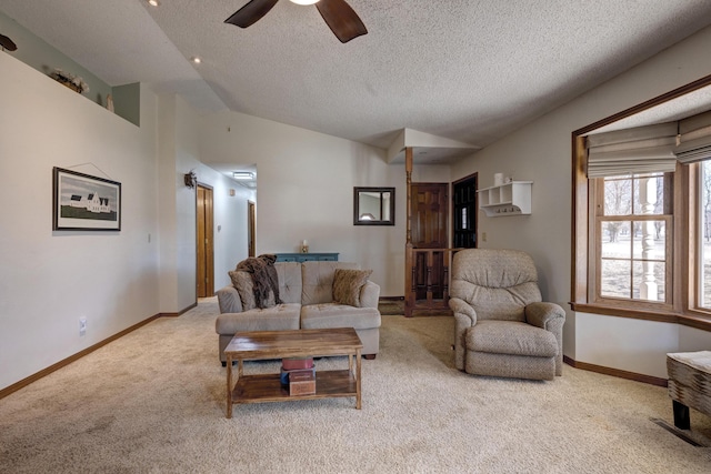 living area with carpet, a ceiling fan, vaulted ceiling, a textured ceiling, and baseboards