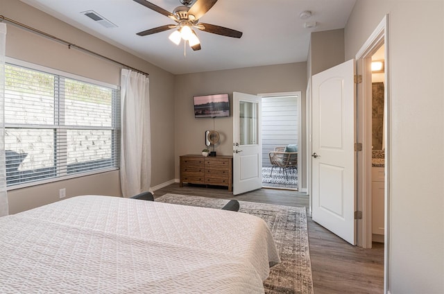 bedroom with baseboards, visible vents, ceiling fan, and wood finished floors