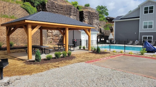 exterior space with a patio, fence, a fenced in pool, and a gazebo