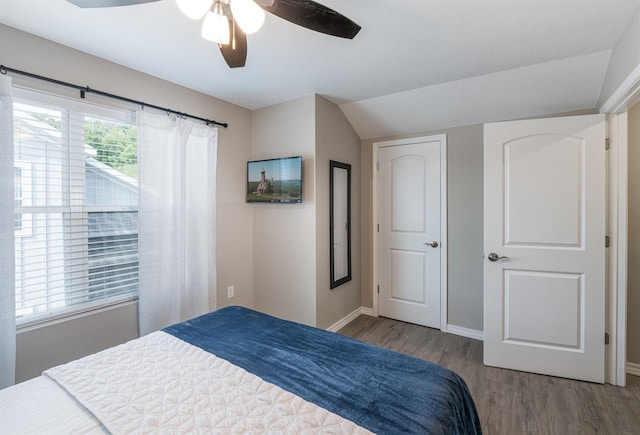 bedroom with ceiling fan, baseboards, and wood finished floors