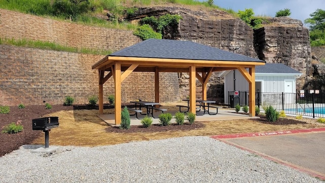 view of property's community with a patio area, fence, and a gazebo