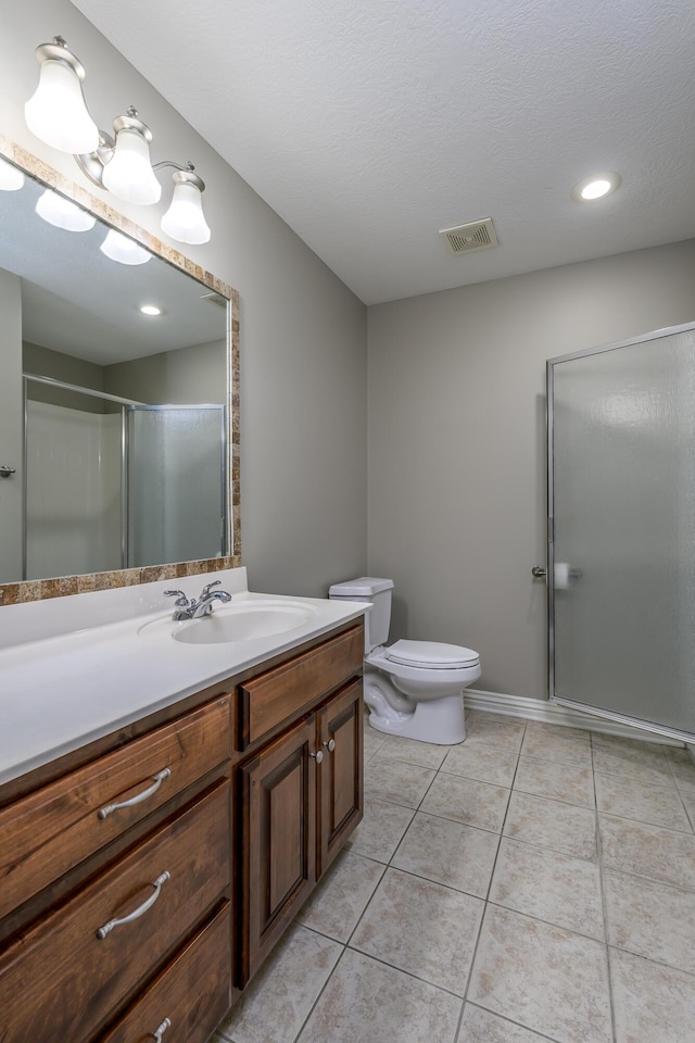 full bathroom featuring visible vents, toilet, a shower with shower door, tile patterned floors, and vanity