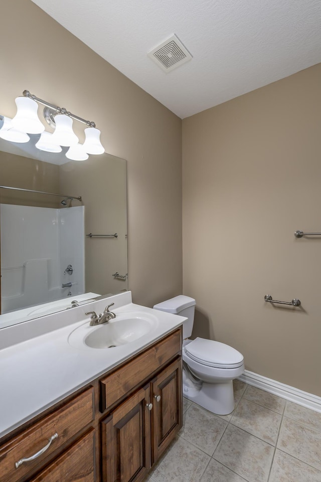 bathroom featuring tile patterned flooring, toilet, vanity, visible vents, and baseboards