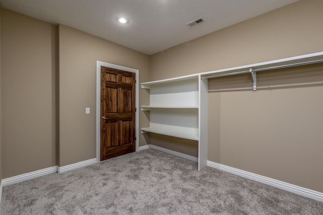 walk in closet featuring carpet and visible vents