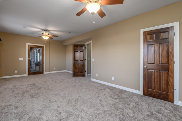 spare room with visible vents, carpet flooring, a ceiling fan, and baseboards