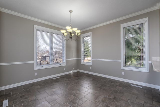 spare room with an inviting chandelier, baseboards, visible vents, and crown molding