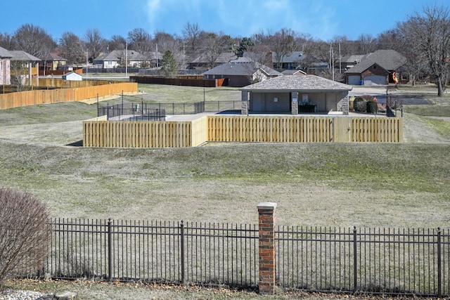 view of yard featuring fence and a residential view