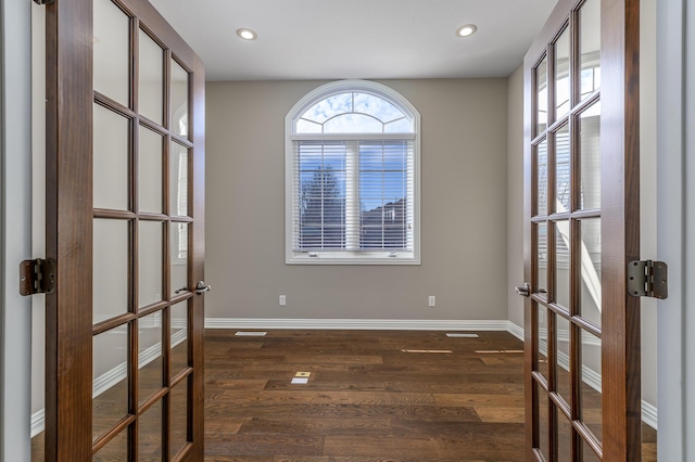 spare room with french doors, dark wood-type flooring, recessed lighting, and baseboards