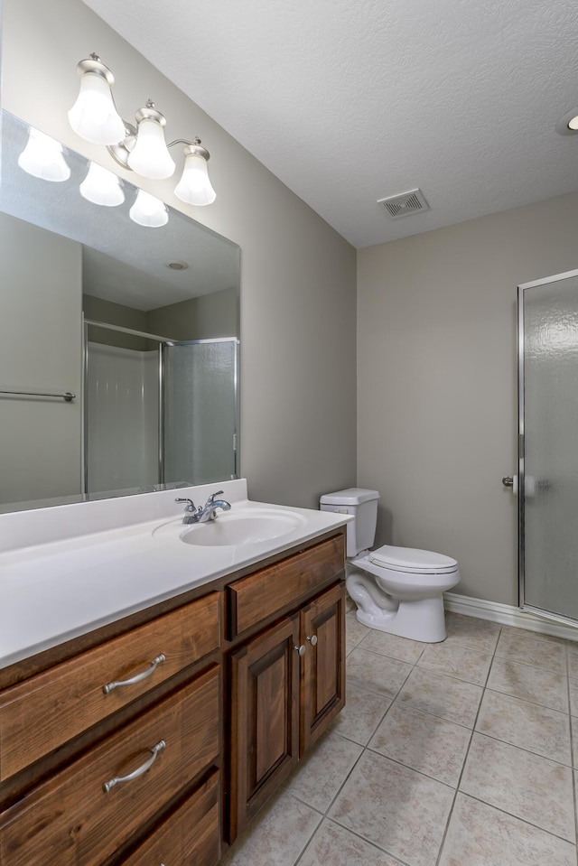 full bathroom with a stall shower, visible vents, toilet, tile patterned floors, and vanity