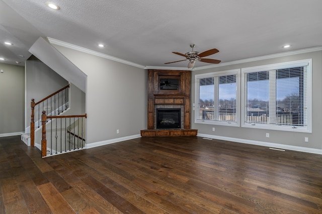 unfurnished living room featuring recessed lighting, ornamental molding, a large fireplace, wood finished floors, and baseboards