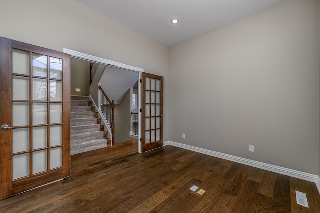 spare room featuring recessed lighting, wood finished floors, visible vents, baseboards, and stairway