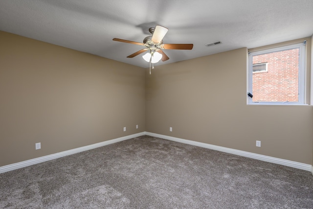 unfurnished room featuring carpet flooring, visible vents, baseboards, and a textured ceiling