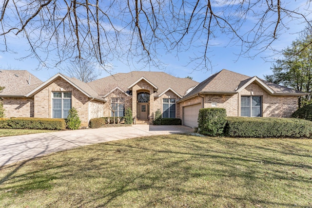 view of front facade with an attached garage, brick siding, driveway, roof with shingles, and a front lawn